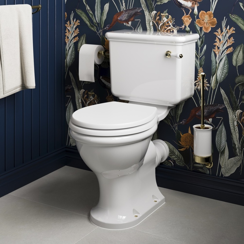 Product lifestyle image of Burlington Guild Close Coupled Toilet against blue wall with floral pattern and wall mounted toilet brush. GU6115CW GU7005CW